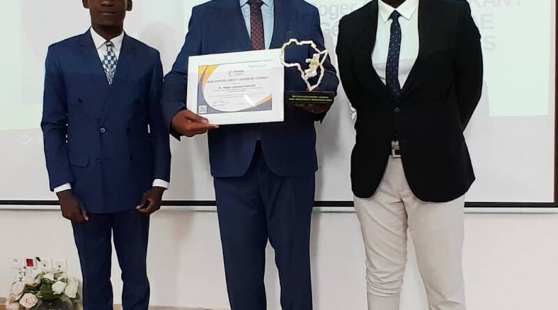 Il a reçu le diplôme et le trophée d'honneur, lors de la 3e édition du '' Trophée Mwana Mboka '', visant à encourager son parcours éloquent, ses qualités pédagogiques indiscutables et son dévouement sans faille à la cause de l'enseignement supérieur.